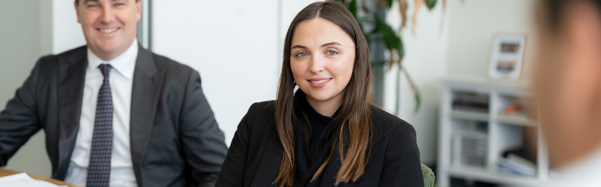 man and woman smiling at client